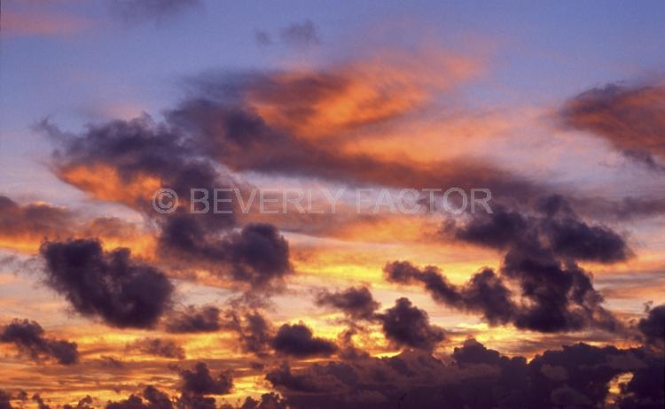 Islands;sunsets;sky;clouds;colorful;blue water;sun;yellow;red;pink;sillouettes;blue;silver banks domincon republic